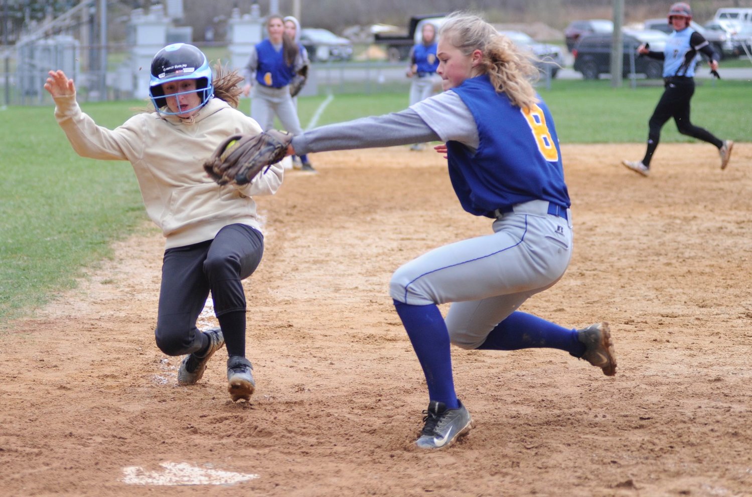 Sullivan West’s Kaylee DiBiase slides into home at the bottom of the seventh inning to win the game 10-9, just beating the tag by Chapel Field hurler Emma Spanjer.